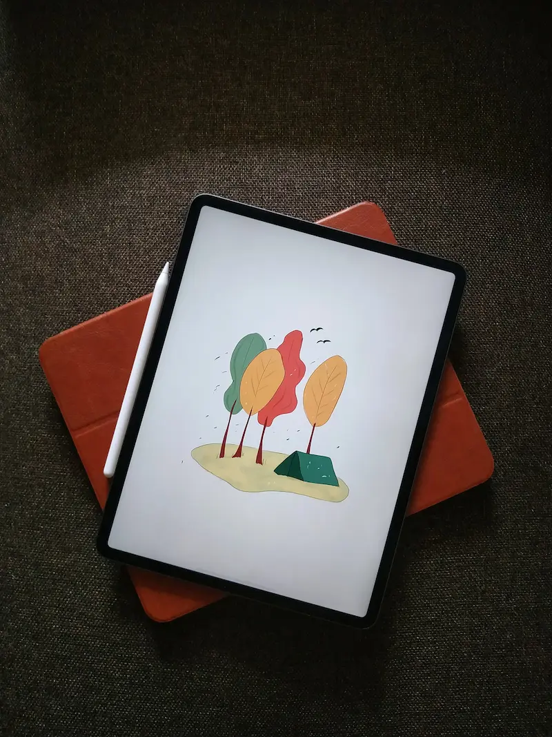 tablet der ligger på et rødt cover